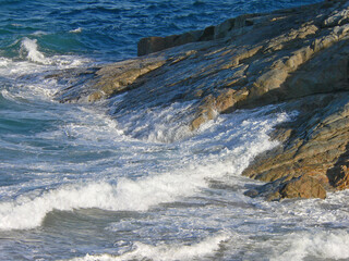 Waves crashing over rocks at 1770 in Queensland, Australia