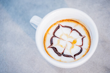 Close up of coffee mug decorated pour stream milk to make latte art. 