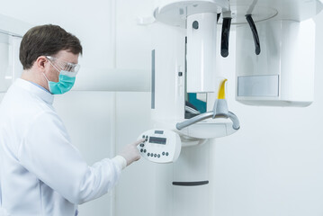 Caucasian male dentist wear mask standing prepare in dental exam room. 