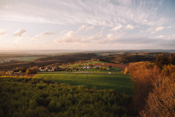 Fototapeta premium Landscape over summer meadow at sunset. Natural rural scene of fields and colorful sky. Dierscheid,Germany.