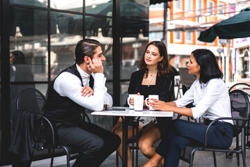 Group of cheerful young friend discussing meeting and talk enjoying their time drinking coffee together.Mixed race people sitting at cafe table and restaurant