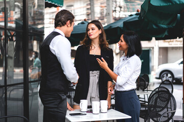 Group of cheerful young friend discussing meeting and talk enjoying their time drinking coffee together.Mixed race people sitting at cafe table and restaurant