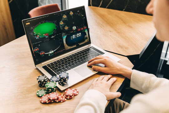 Young man play online poker in laptop.