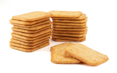 Fototapeta na wymiar Salty square crackers isolated on bright background. Close up view.
