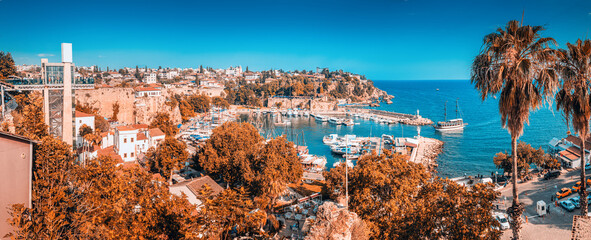 tourist cruise ship or yacht is sailing to Antalya old town harbor from open sea. Trip and...