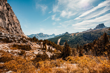 Mountain climber on a steep and exposed Via Ferrata Col dei Bos near passo falzarego. Autumn Passo...