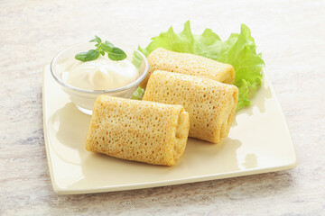 Stuffed pancakes with meat and cream