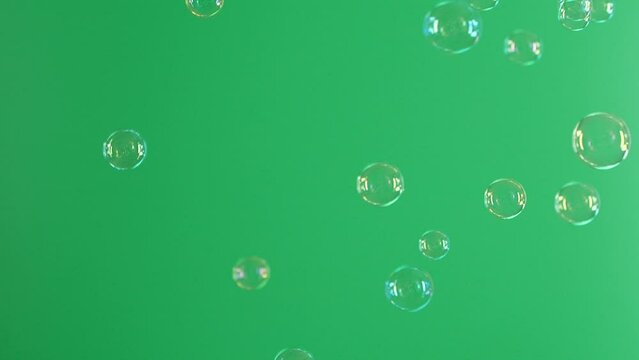 Slow motion of soap air bubbles texture on chroma key green screen background