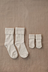 Pastel cozy eco friendly stylish Scandinavian newborn baby and mother's socks. Online fashion store, online shopping branding concept. Neutral colours