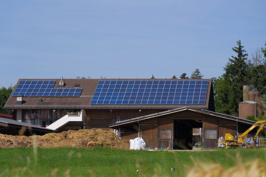Farm buildings with solar panels on pitched roof at City of Wallisellen, Canton Zürich, on a sunny summer day. Photo taken June 17th, 2022, Wallisellen, Switzerland.