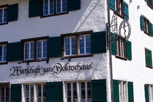 Sign at historic house, formally a medical doctor's house, now a restaurant at City of Wallisellen near City of Z&uuml;rich on a sunny summer day. Photo taken June 17th, 2022, Wallisellen, Switzerland.