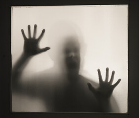 Shadowy figure behind glass - horror background
