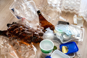 Miscellaneous waste for recycling piled up on the floor. Household waste collection for recycling.