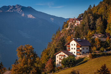 Hafling, Italy - Traditional tirol houses at Hafling - Avelengo on a warm autumn sunset with the Italian Dolomites in South Tyrol at background - obrazy, fototapety, plakaty