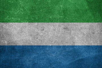 Old leather shabby background in colors of national flag. Sierra Leone