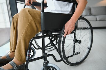 Obraz premium middle aged woman sitting on wheelchair