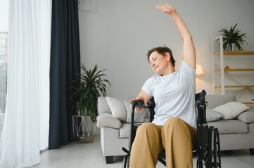 Woman in wheelchair working out in living room