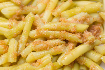 yellow vax beans with fried bread crumbs closeup selective focus