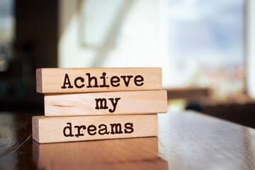 Wooden blocks with words 'Achieve my dreams'.