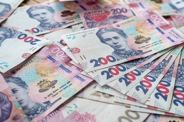 in the photo a lot of Ukrainian hryvnias scattered on the surface.