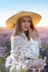 Young blonde woman in   sitting on lavender field