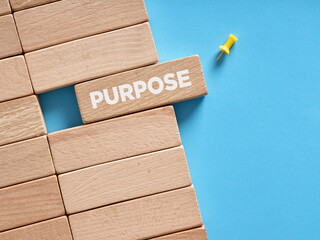 The word purpose written on wooden blocks. To find a purpose concept.