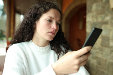 Fototapeta na wymiar Woman checking phone in a restaurant