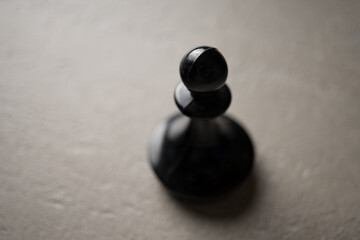Naklejka na ściany i meble Chess piece Pawn close-up on a light background, the concept of an idea, promotion, success