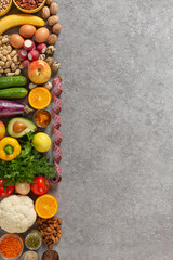 VEGETARIAN assortment of vegetables and fruits, nuts and herbs in a flat lay composition with copy space