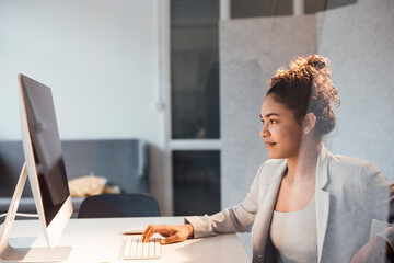 Young businesswoman working on computer in office
