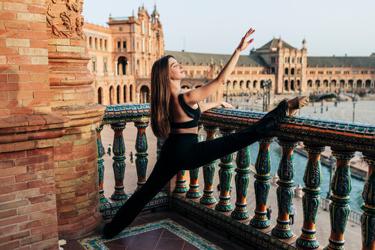 Ballet dancer dancing in building balcony at Plaza de Espana in Spain