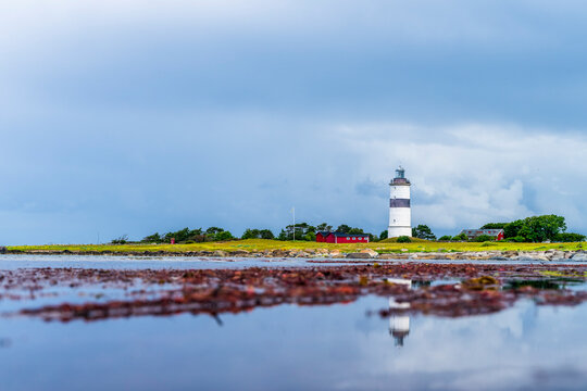 Sweden, Halland, Falkenberg, Cloudy sky over lighthouse in Morups Tange reserve