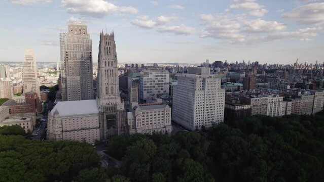 Riverside Church and the Upper Manhattan cityscape, in sunny NYC, USA - aerial view