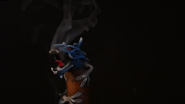 Chinese long dragon statue exhaling smoke while rotating in a studio