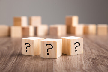 wooden blocks with question marks on wooden table
