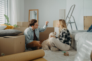 Cheerful young couple in their new apartment. Conception of moving.