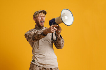 European military man wearing uniform shouting in megaphone