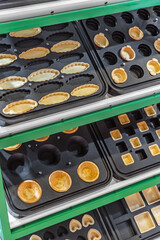 various forms for baking waffles and cakes in a pastry shop