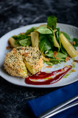 gray in batter with spinach leaves in a plate macro photo

