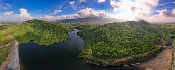 Aerial panoramic landscape with green hills, river and forest