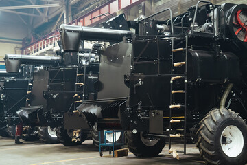 Factory hangar with combine harvesters assembled. Industrial production of agricultural machinery.