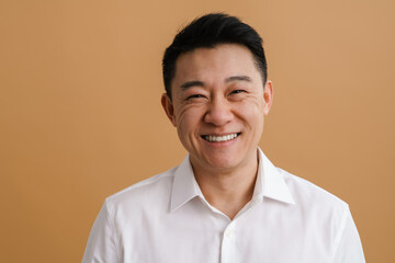 Brunette adult asian man wearing shirt smiling at camera