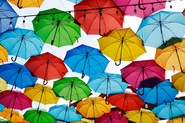 Fototapeta na wymiar Colorful umbrellas used as a decoration over a walkway