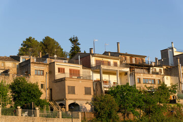 Fototapeta na wymiar Talamanca, Bages - July 9, 2022: Group of houses with sunset color on the buildings