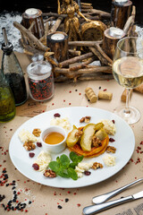 breakfast baked fruits with cottage cheese nuts and honey in a plate vertical photo
