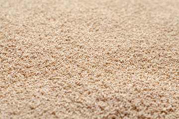 Background, texture from dry granular yeast, top view. Active dry yeast, top view. Heap of dry yeast granules, texture. Dry yeast is used in baked goods. Background for use on the label.