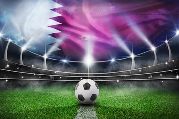 Fotobehang textured soccer game field with a soccer ball on the line in Qatar - center, midfield © Igor Link