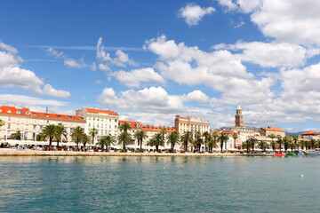Promenade in Split, Croatia with landmark architecture and sailing boats.