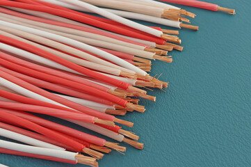 Copper electrical wires on natural colored leather close-up.