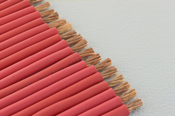Copper electrical wires on natural colored leather close-up.